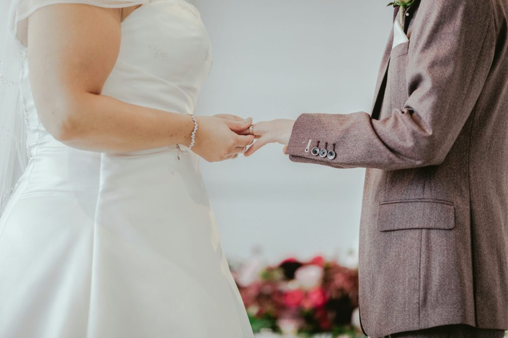 woman holding hands with man in front of altar