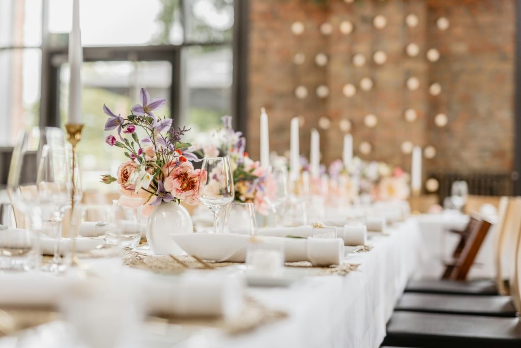 a table with white plates and glasses
